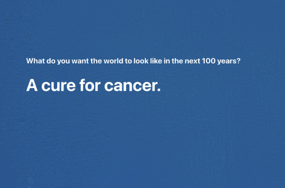 White text on blue background that says what do you want the world to look like in the next 100 years? With the answer "A cure for cancer."